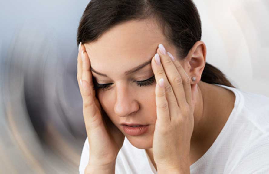 Woman holding her head with dizziness