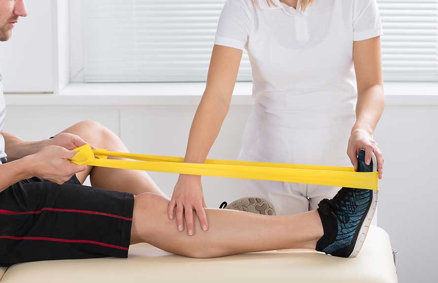 Therapist guiding a patient through a resistance band exercise
