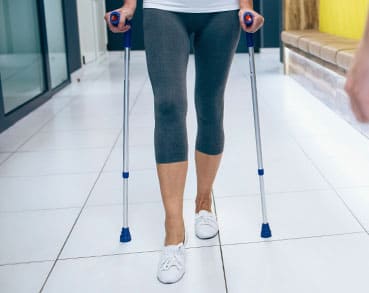 Person walking with crutches