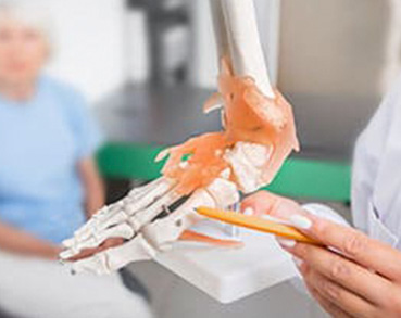 Doctor explaining a foot model
