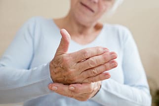 Older woman holding her hand