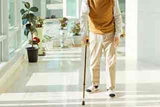 Older man walking with a cane